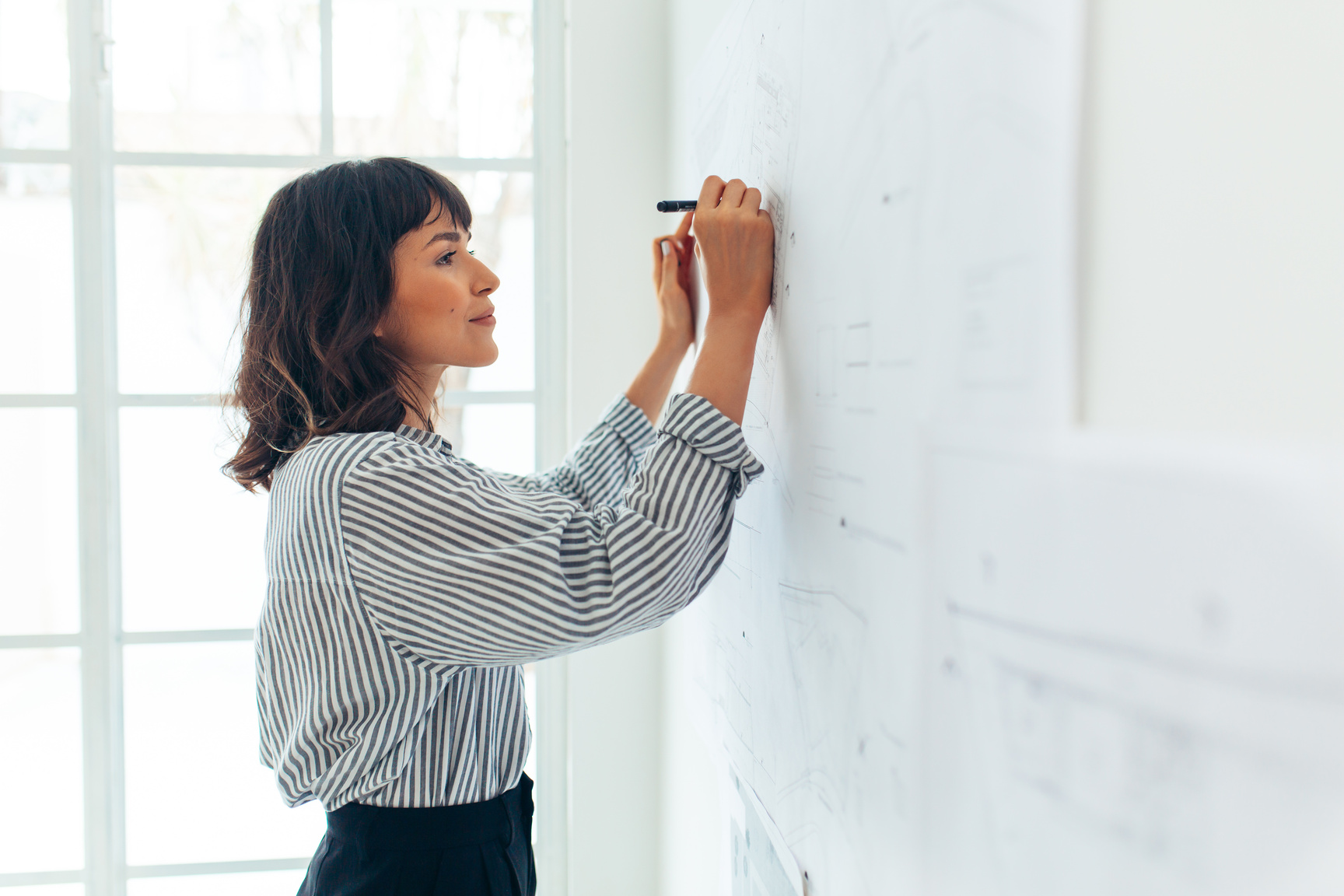 Female architect making designs